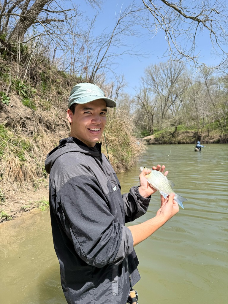 Holding a white bass caught at The Steps on a spring day